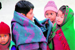 With mercury taking a dip in the region, these children seem to ensure full protection against chill by putting on multi-layered woollen clothing in Chandigarh on Monday.