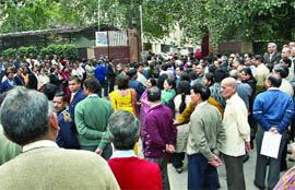 Employees of Reserve Bank of India stand outside as the building was evacuated during a fire drill in New Delhi on Monday afternoon.