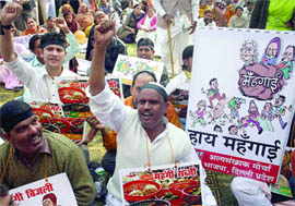 BJP activists demonstrate against price hike outside Delhi Assembly in New Delhi on Monday.