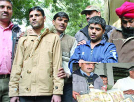 The three accused of making fake notes being produced before the media at Delhi police special cell office in Lodhi Road on Monday.