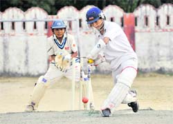 A batsman plays a shot in a match at the 58th District Cricket League in Dehradun on Monday.