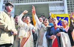 Members of the RTI Lok Sewa agitate in front of the District Magistrates office in Dehradun on Monday.