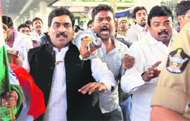 Supporters raise slogans as the police arrests Lagadapati Rajagopal (in black jacket), a Congress MP from Vijayawada, who was preparing to begin a fast in protest against state's division, in Hyderabad on Monday.