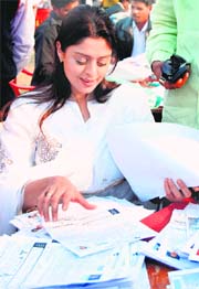 Congress MP Nagma checks application forms during a youth membership drive in Lucknow on Monday.