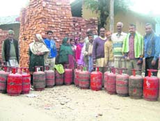 Residents of Shodi village in Kangra subdivision queue up to get their LPG cylinders refilled.