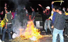 Youths protest after a canecharge by the police during the Punjabi singer Jazzy B nite at MA Stadium in Jammu.