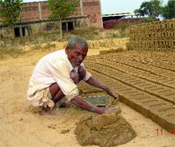 An aged labourer works at a brick-kiln in Jalandhar
