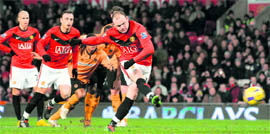 Manchester Uniteds Wayne Rooney scores a penalty against Wolverhampton Wanderers at Old Trafford on Wednesday.  AFP