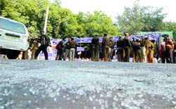 Broken pieces of a car windowpane lie on the road after members of the All-India Confederation of Scheduled Caste and Scheduled Tribes turned violent at Jantar Mantar in New Delhi on Thursday.
