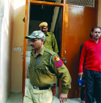Delhi cops coming out from Raj Chutanis house at East of Kailash in New Delhi, where robbers struck on Thursday.