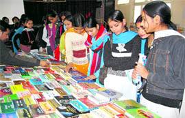 Girls at a book exhibition at MKP College, Dehradun, on Thursday.