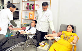 Volunteers donate blood at a camp held at Dev Bhoomi Institute of Hotel Management in Dehradun on Thursday.