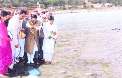 Chief Minister Ramesh Pokhriyal Nishank inaugurates the Sparsh Ganga campaign by pouring milk into the river at Rishikesh