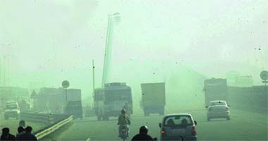 Poor visibility forces motorists to move cautiously on the Delhi-Jaipur national highway in Gurgaon