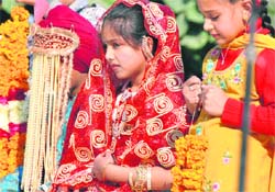 Students dressed as bride and groom during Punjabi Divas celebrations at Alpine International School in Ludhiana on Thursday. 