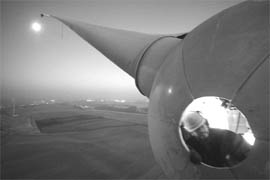 A worker is seen at the top of a power-generating windmill turbine in a wind farm in Fruges, near Saint Omer, northern France, in January, 2009. The wind farm, which has 70 power-generating 2-MW windmill turbines, is capable of producing 140 MW of green energy. That is enough to power some 1,50,000 households.