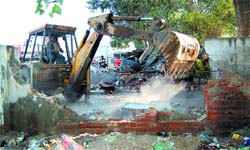 Illegal encroachments being demolished outside Cosmo Club in Amritsar.