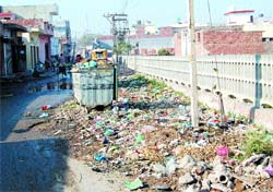 Garbage lies scattered near a park in Tung Bala area.