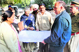 UT chief architect Sumit Kaur discusses the road map with police officials for erecting gates at entry points in Sector 15, Chandigarh, on Friday.