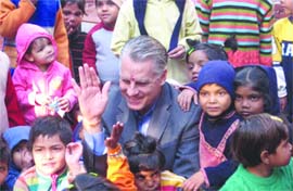 The US ambassador to India Timothy J. Roemer poses with children at SOS Orphanage in New Delhi