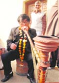 A member of a Vietnamese delegation enjoys a hookah at Jharsa village.