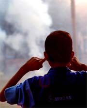 A child reacts to cracker explosions by plugging his ears at the opening ceremony of Commonwealth Wrestling Championship at the PAP Grounds in Jalandhar on Friday.