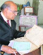 Sohan Lal Gupta goes through the records at the office of the registrar of births and deaths in Ludhiana.