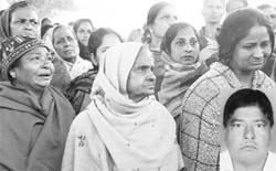 Family members of Vilayti Raj, a CTU driver (inset), protest outside the office of the DSP, Dera Bassi, after his death on Saturday. 