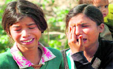 Two girls cry as their huts are demolished by JVC machines as part of the drive carried out last week in Haridwar