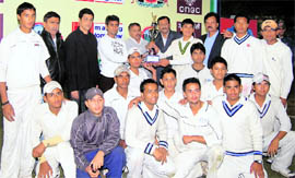 The Nainital team pose with the winners trophy of the Inter-District Cricket Championship in Dehradun on Saturday. A Tribune photograph