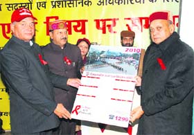 Chief Minister PK Dhumal releases a calendar on AIDS awareness at Dharamsala