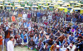 Auto drivers protest against the state governments plan to phase out autorickshaws from the city roads, in New Delhi on Sunday.