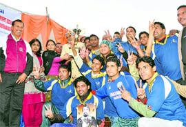Nagar Nigam team players show victory sign after lifting the MK Bisht Memorial Football tournament in Dehradun on Sunday