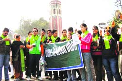 Activists of Citizens for Green Doon hold a demonstration against the felling of trees in Dehradun on Sunday. 