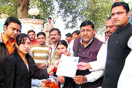 Congress MP from Sirsa Ashok Tanwar (extreme right) receives an IYC membership form from a young recruit in Sirsa on Sunday.