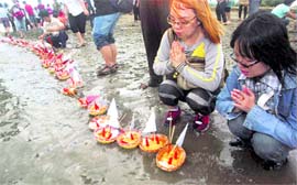 Buddhists, commemorating the fifth anniversary of the tsunami, pray and release offerings into the Indian Ocean during a ceremony on Ulhee Lheu beach in Banda Aceh, Indonesia, on Sunday. A quake in the Indian Ocean on December 26, 2004, triggered a massive tsunami that killed 230,000 people, half of them in this region
