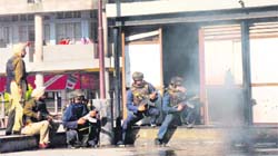Police officials take positions after hurling tear gas shells at Sector 17, Chandigarh,