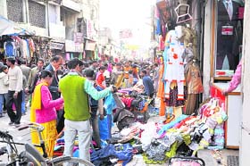 Clothes displayed on road blocking traffic at Paltan Bazar in Dehradun