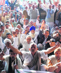 Members of the Bharatiya Kisan Union hold a protest in Karnal opposing the installation of transformers in fields on Monday. 