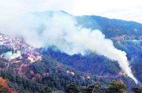 Smoke rises from the fire that broke out in the heaps of garbage near Shimla