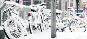 Snow-covered bicycles on the side of a Munich street on Monday.