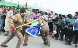 Policemen cane-charge protesting daily wage workers of the Power Development Department in Srinagar
