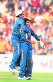 Virender Sehwag (L) congratulates Ravindra Jadeja on taking a wicket at Cuttack on Monday. Jadeja picked four wickets for 32 runs.