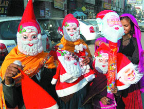 Christmas fever: Poor kids sell masks of Santa Claus in Amritsar.