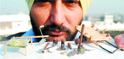 Harvinder Singh Gill shows his miniature creations.