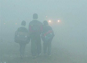 Amidst dense fog, children on their way to schools in Amritsar.