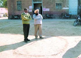 PSEB Additional SDO Jagdev Sokhal and SDO Surinder Singh Behal standing inside the circle at Abohar