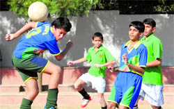 Players of Ashiana School and St Johns School in action during a semifinal match in Sector 26, Chandigarh, on Tuesday.