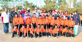 Sports director Pargat Singh with budding players at a new hockey academy at Bassi Pathana.