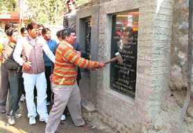 Congress workers demolish plaques of Kumbh works.